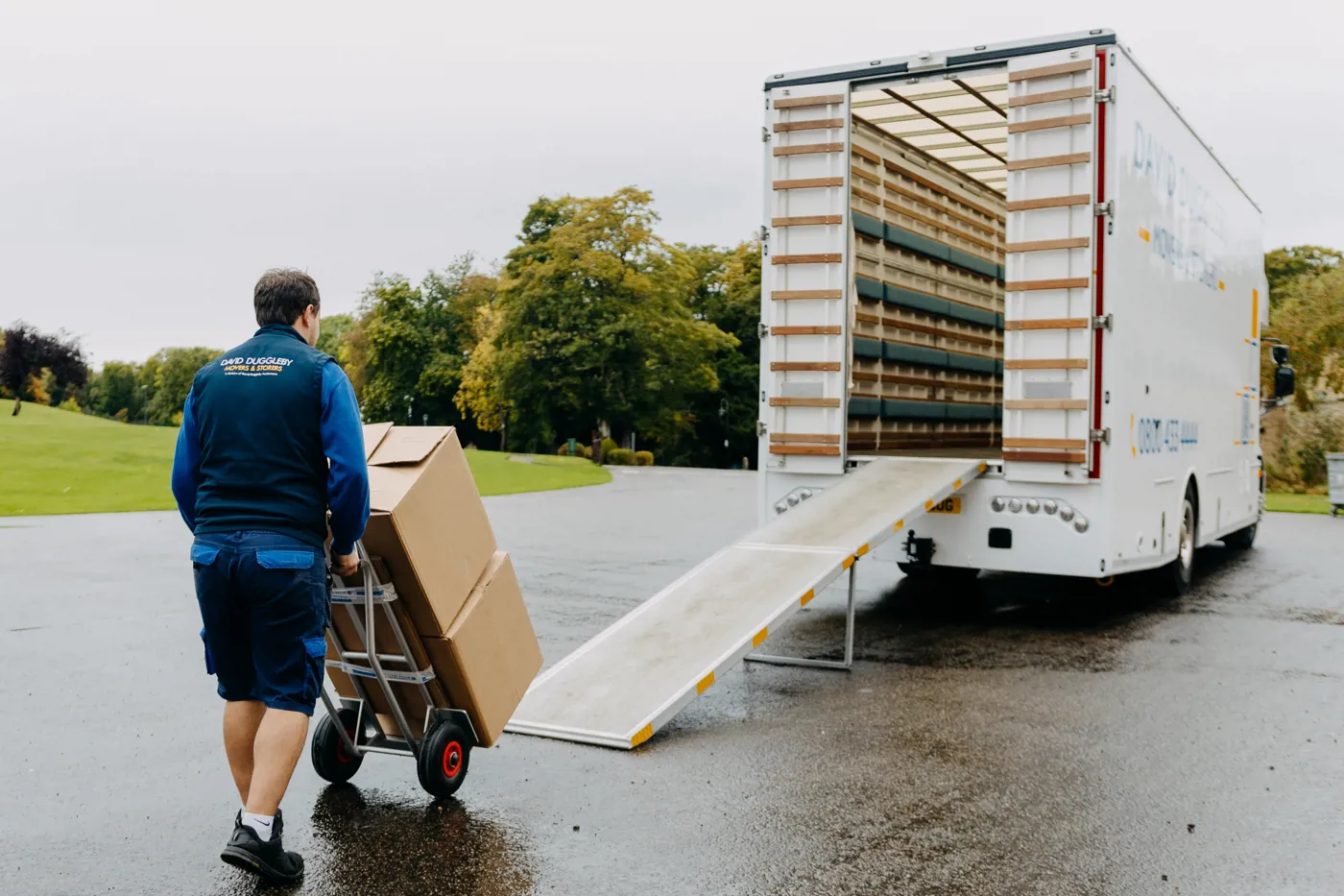 Mover loading boxes into a removal van